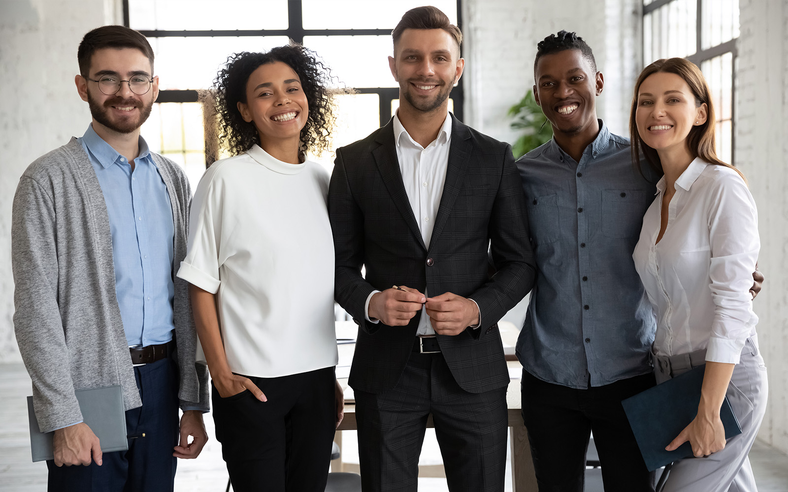 オフィスで並ぶビジネスチームの集合写真