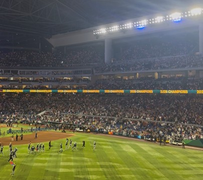 Packed baseball stadium during the World Baseball Classic final, with players on the field and a full crowd under stadium lights